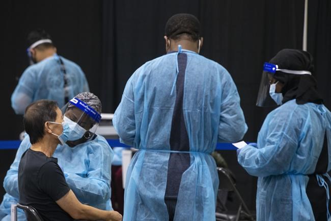 Parts of Canada begin 2022 with record COVID-19 cases after low-key New Year's Eve | iNFOnews.ca CP656110463