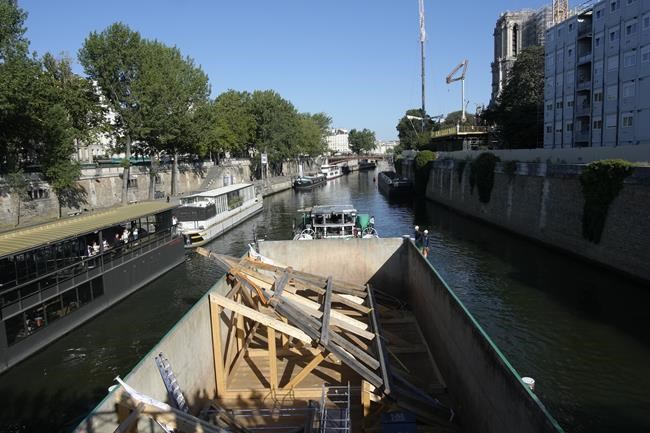 Oak trusses raised to roof of fire-ravaged Notre Dame Cathedral as crowds watch along the Seine | iNFOnews.ca