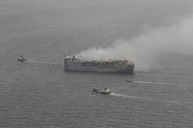 Tugs tow burning cargo ship to new location on North Sea while salvage crews ponder next steps | iNFOnews.ca