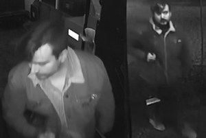 A man in black and white security footage.