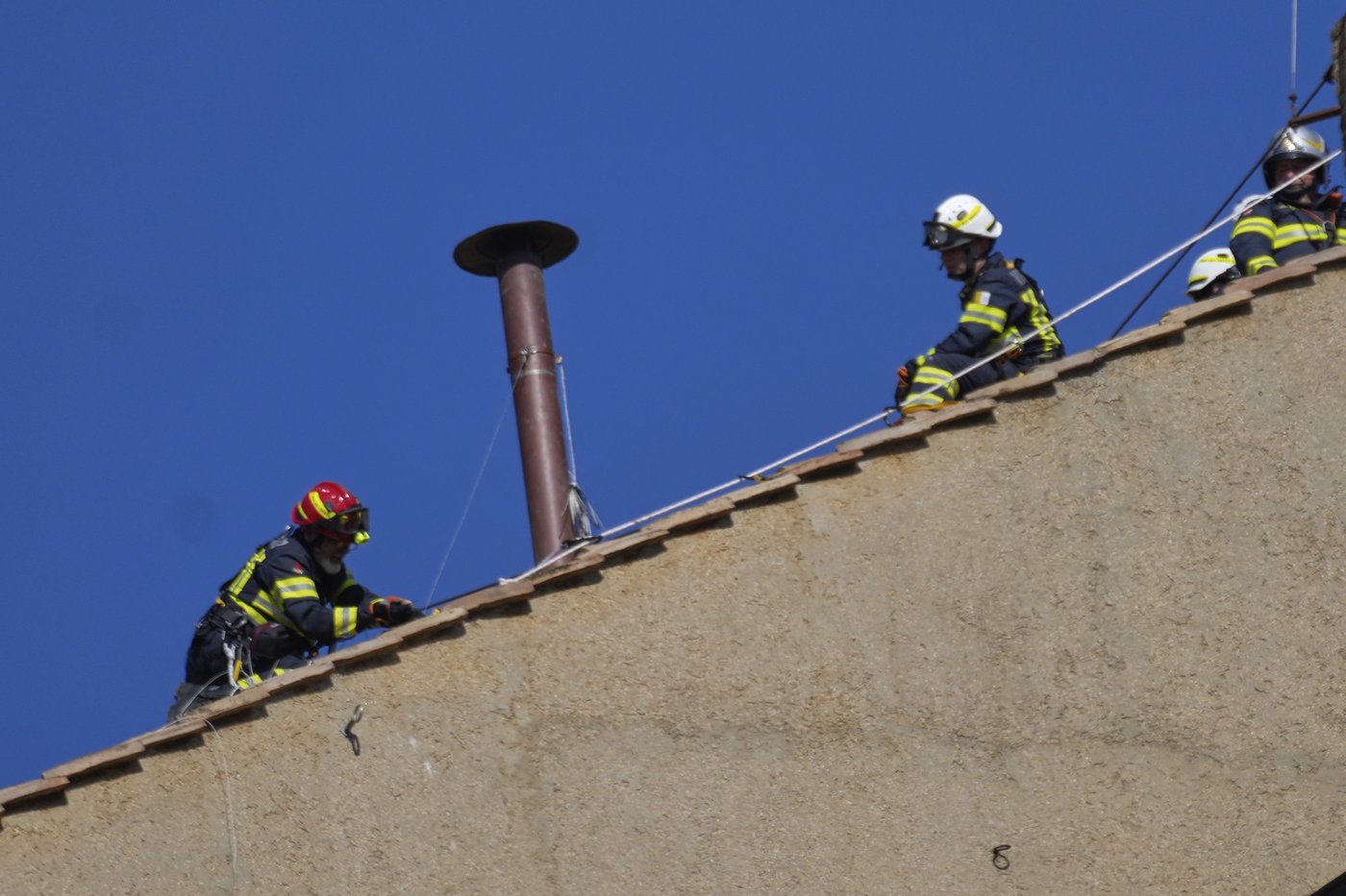 Vatican firefighters install a chimney on the roof of the Sistine Chapel for the papal election | iNFOnews.ca