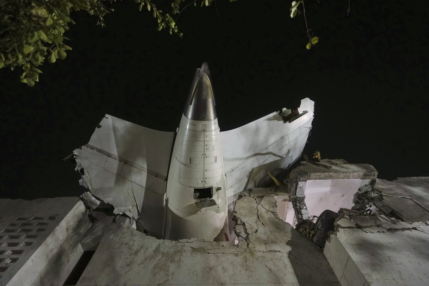 AP PHOTO: Air India plane's tail juts from a building | iNFOnews.ca