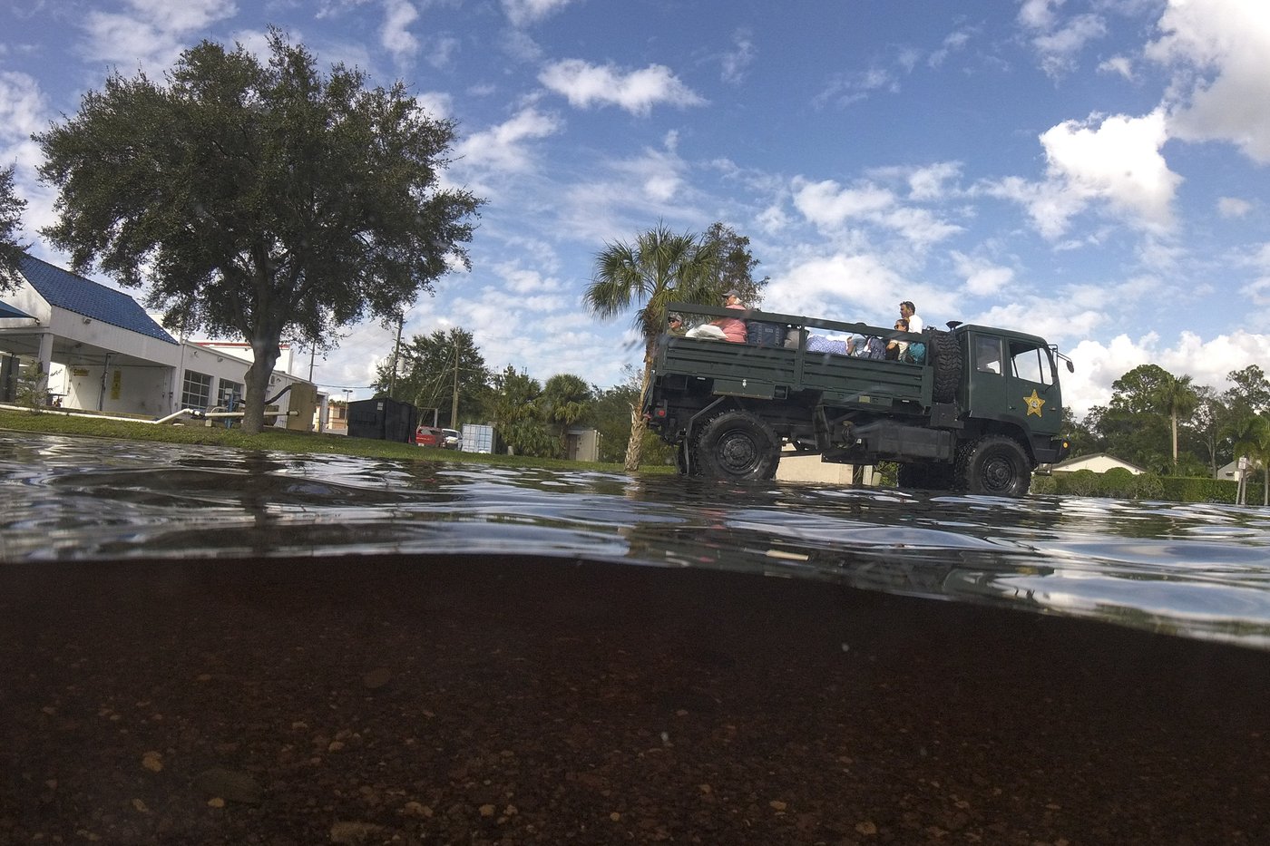 Residents slog through flooded streets, clear debris after Hurricane Milton tore through Florida | iNFOnews.ca