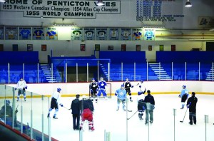 Hockey players on the ice in an arena.
