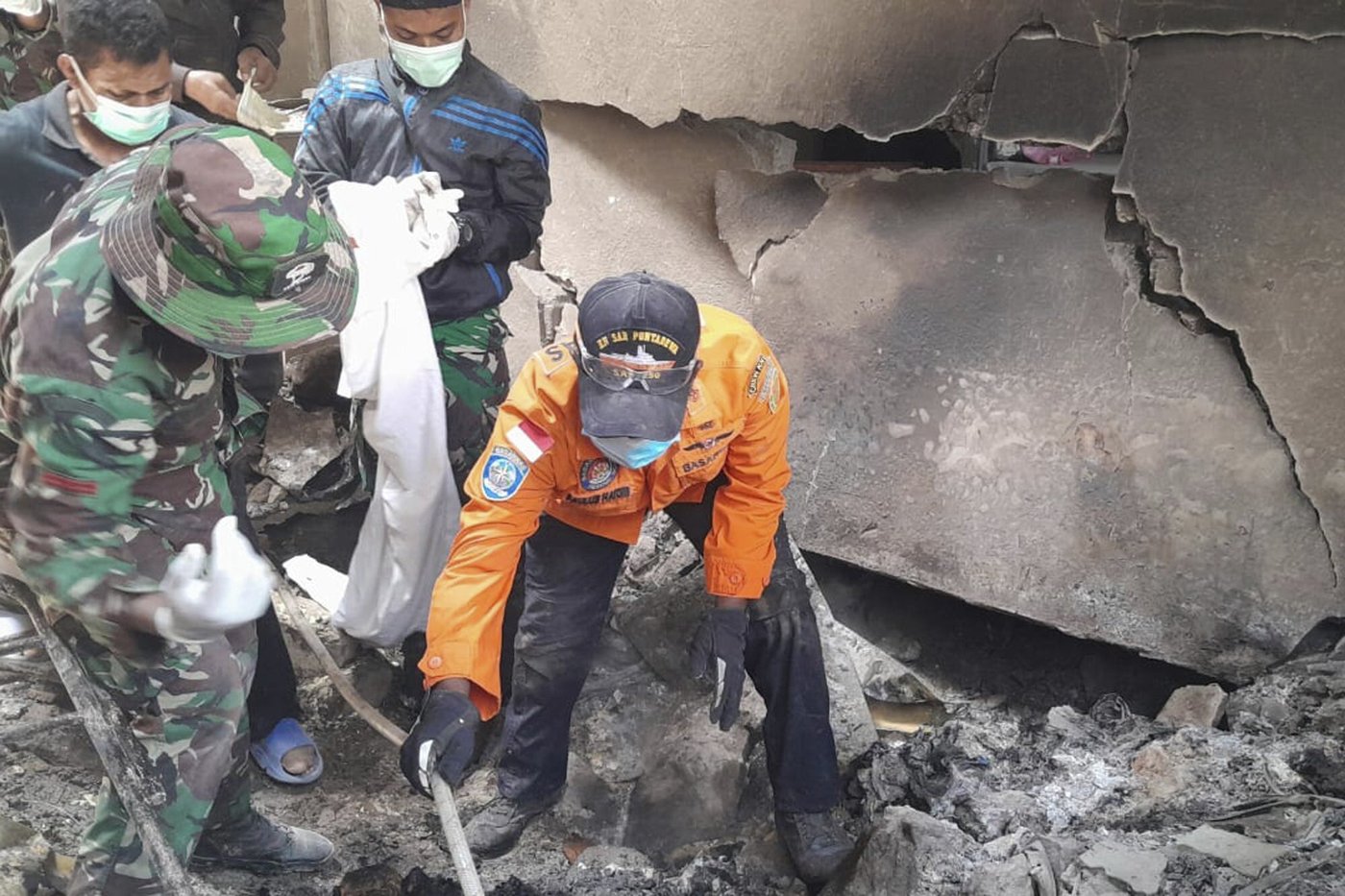 Indonesian rescuers dig through volcanic ash after eruption kills 9 and destroys buildings | iNFOnews.ca