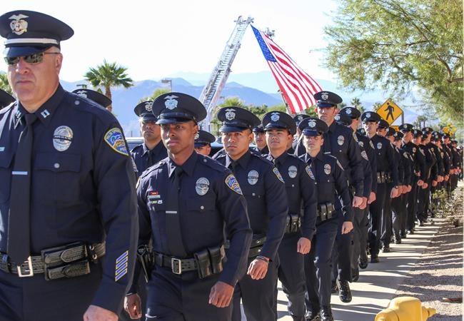 The Latest: Family recalls example set by slain officer | iNFOnews.ca