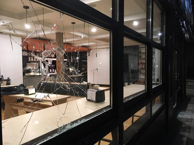 Group of masked, black-clad people roams Hamilton, damaging stores, cars | iNFOnews.ca CP1141630385