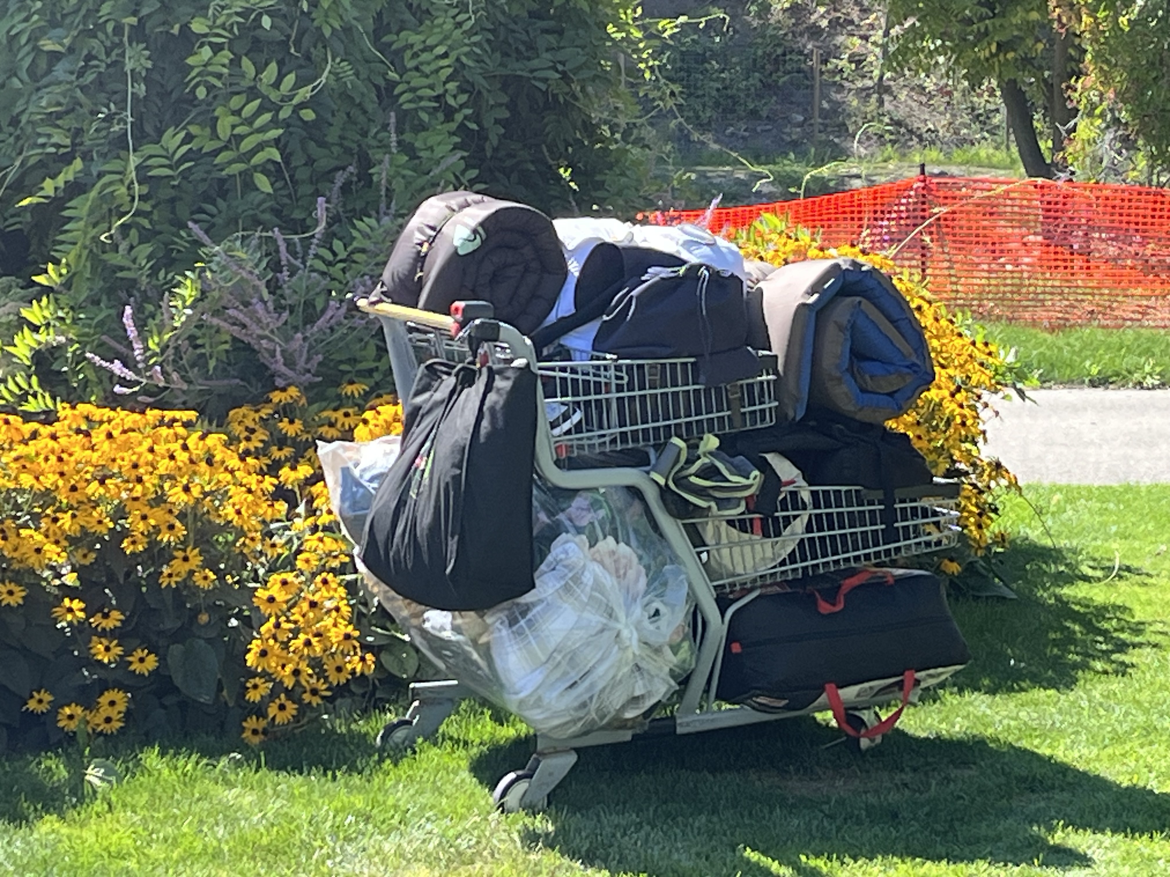 A homeless person's belongings on a shopping cart.