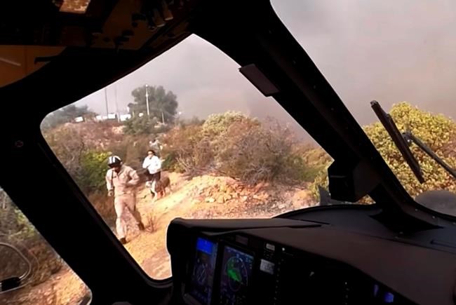 Helicopter crew saves people, pets on peak during wildfire | iNFOnews.ca CP1145381291