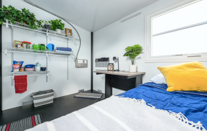 A tiny home with a bedside table and decorations.