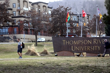 Kamloops cops on hunt for university dorm voyeur | iNFOnews.ca A man walks by a university entrance sign on a grass lawn.