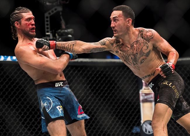 UFC featherweight champion Max Holloway smashes records with bloody UFC 231 win | iNFOnews.ca