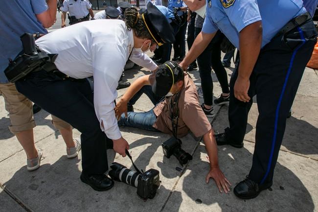 AP journalist punched while walking with police commissioner | iNFOnews.ca