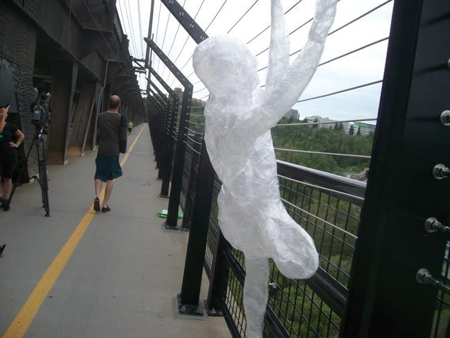 Life-sized human figures made from tape appear on Edmonton bridge | iNFOnews.ca CP296708848