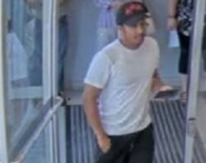 A picture of a man caught on security camera suspected of committing fraud.