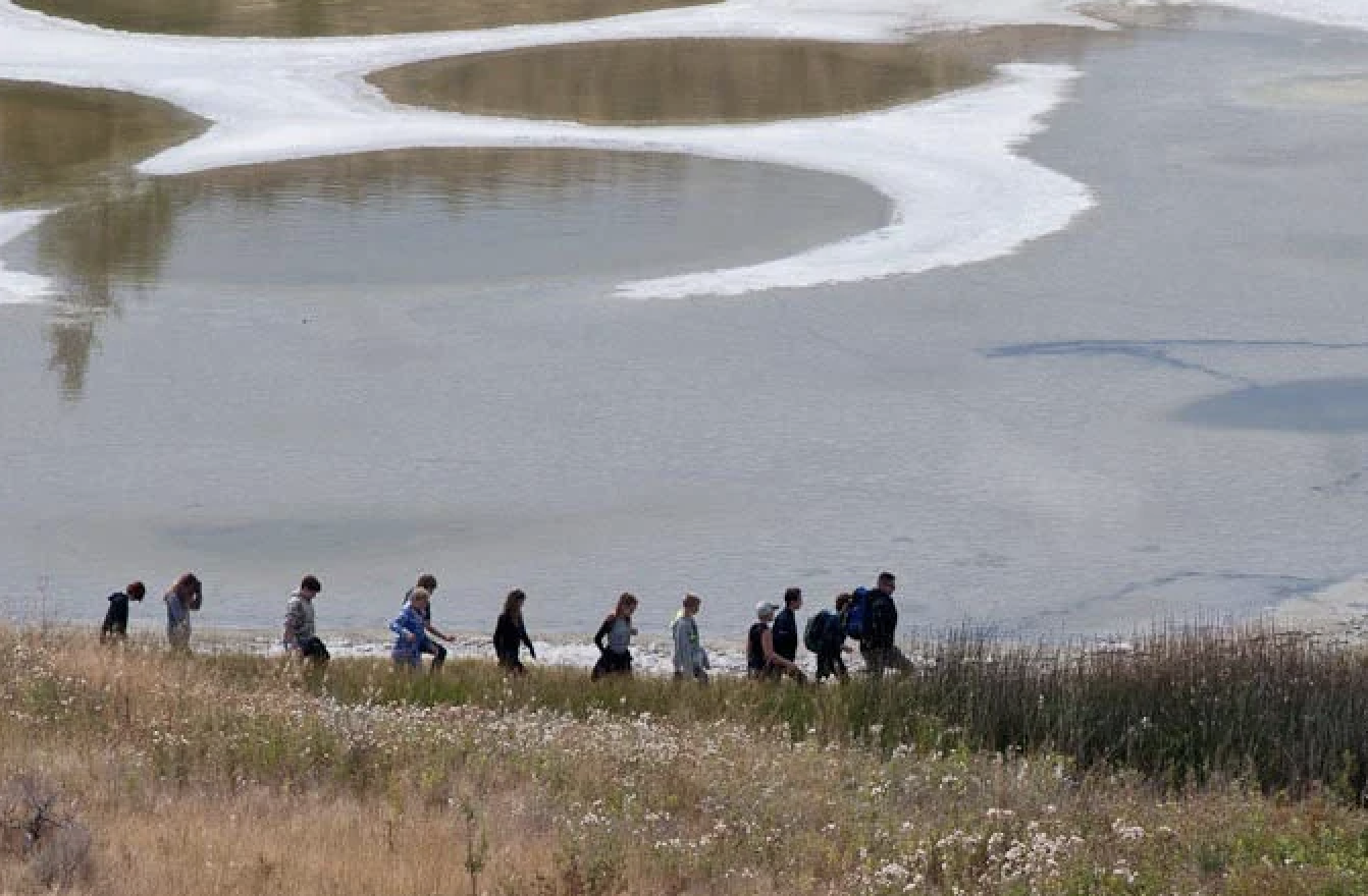 Proposed National Park in South Okanagan still on table 20 years later | iNFOnews.ca People walk along a lake shore.