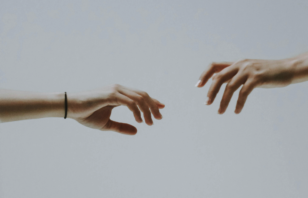 Photo illustration of hands reaching for each other