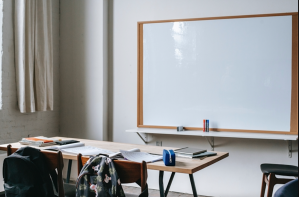 A teacher's desk and white board.