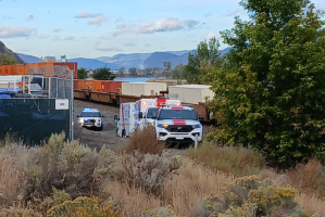 Emergency responders on the scene of a collision on a train track.