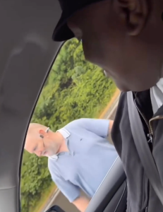A man outside a car window with the driver visible