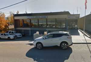 A car parked on the street in front of the Lake Country RCMP detachment.