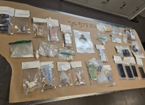 A bunch of seized drugs and cash spread out on a table.