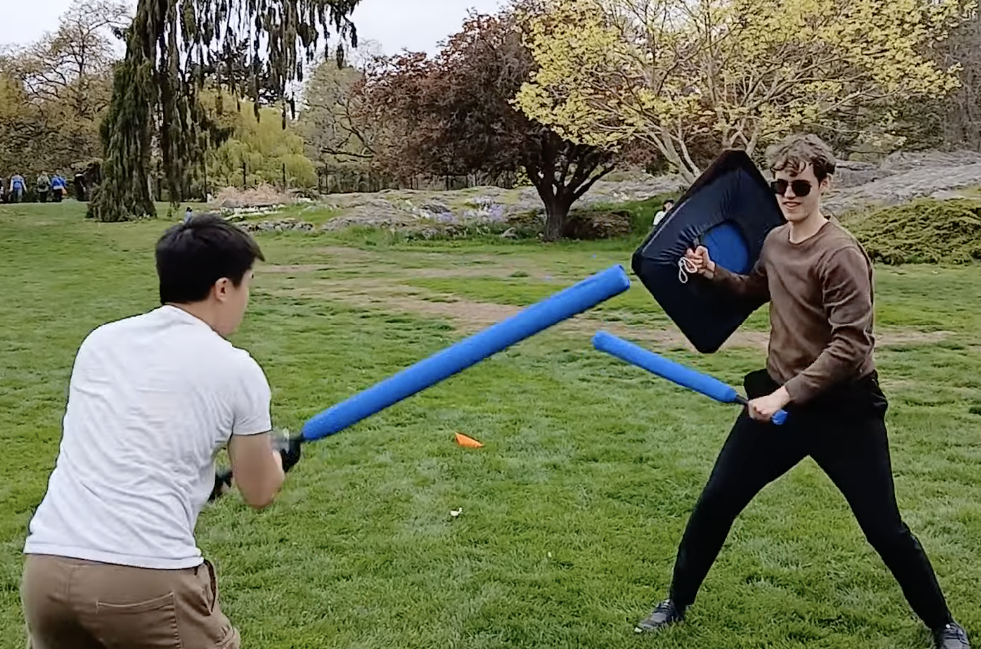 Two men with foam swords have a duel.
