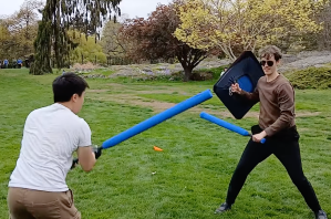 Two men with foam swords have a duel.
