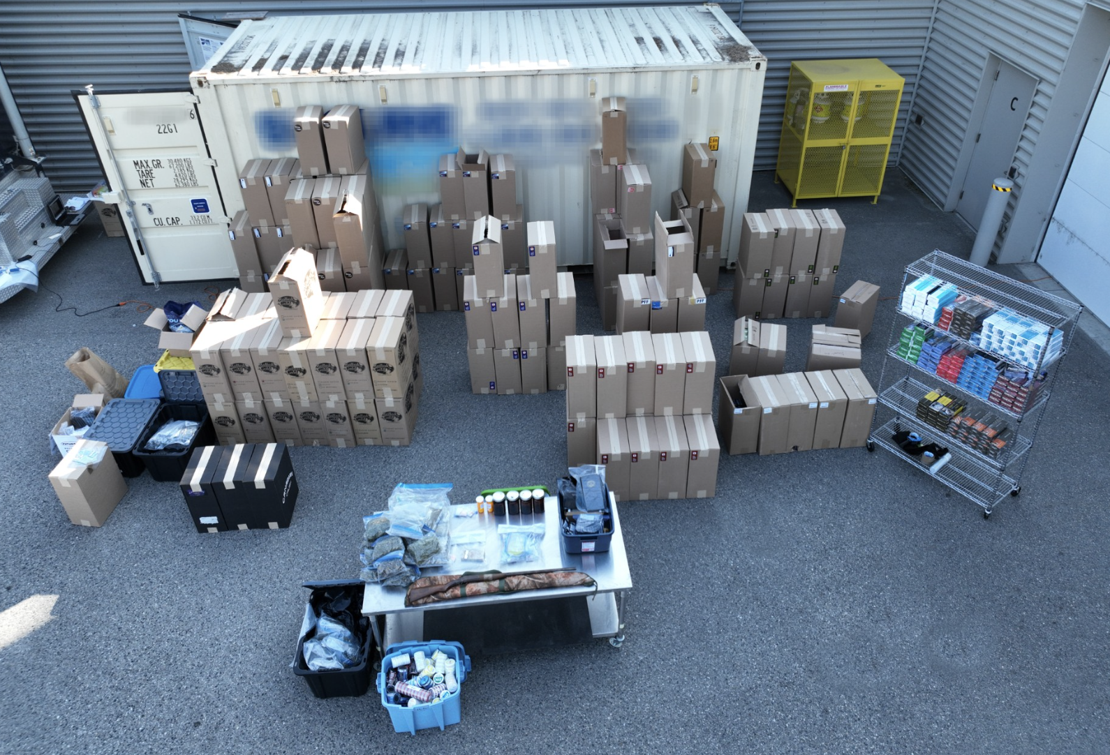 Kelowna cops seize $750,000 worth of illegal cigarettes | iNFOnews.ca Boxes filled with cigarettes and drugs next to a shipping container.