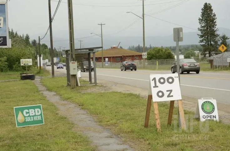 A sign advertising cannabis for $100 an ounce, on the side of the highway in enderby.