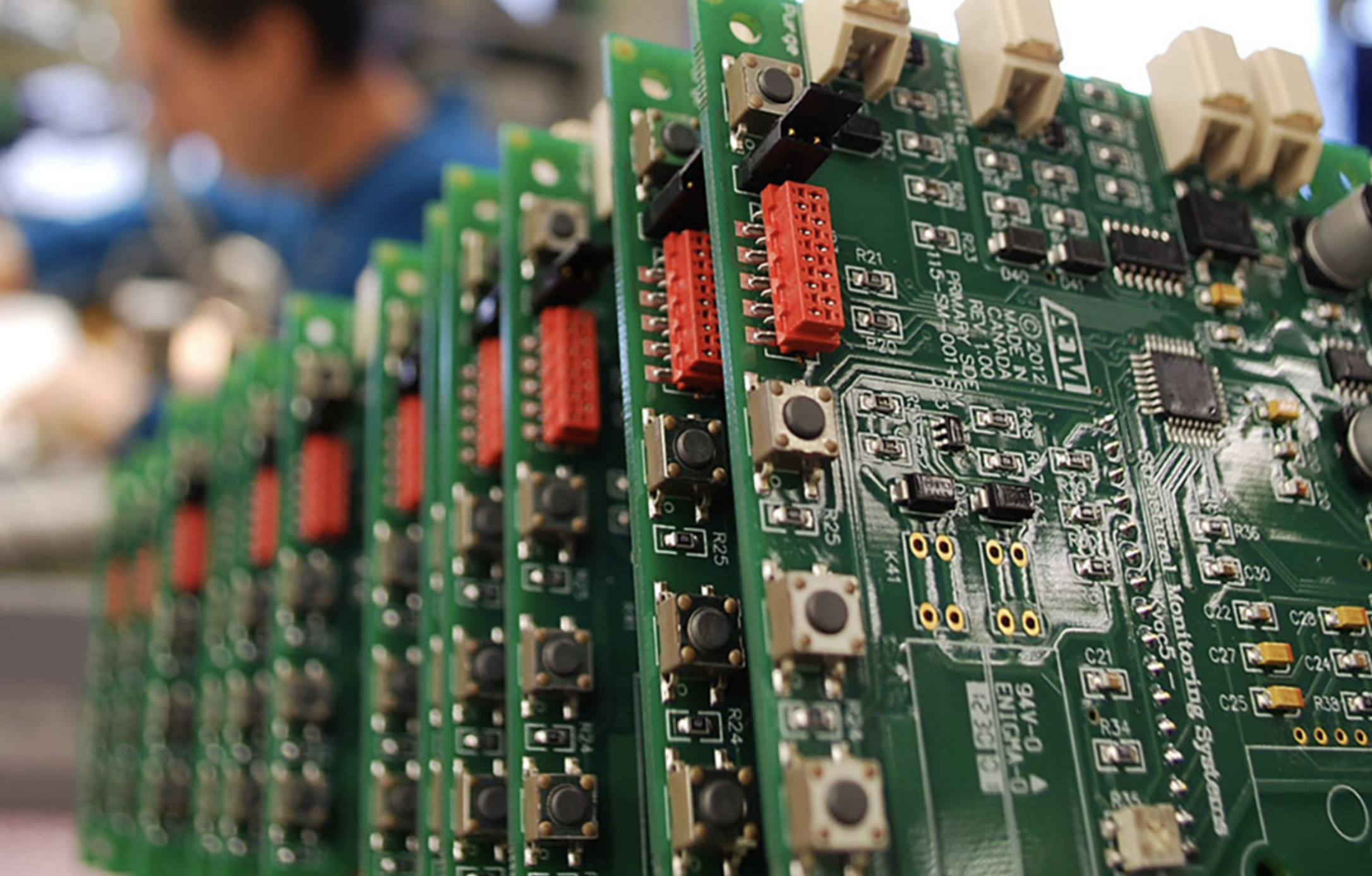 Kelowna’s last bastion for jukebox and old school electronics repair | iNFOnews.ca Some circuit boards with a person blurred in the background.