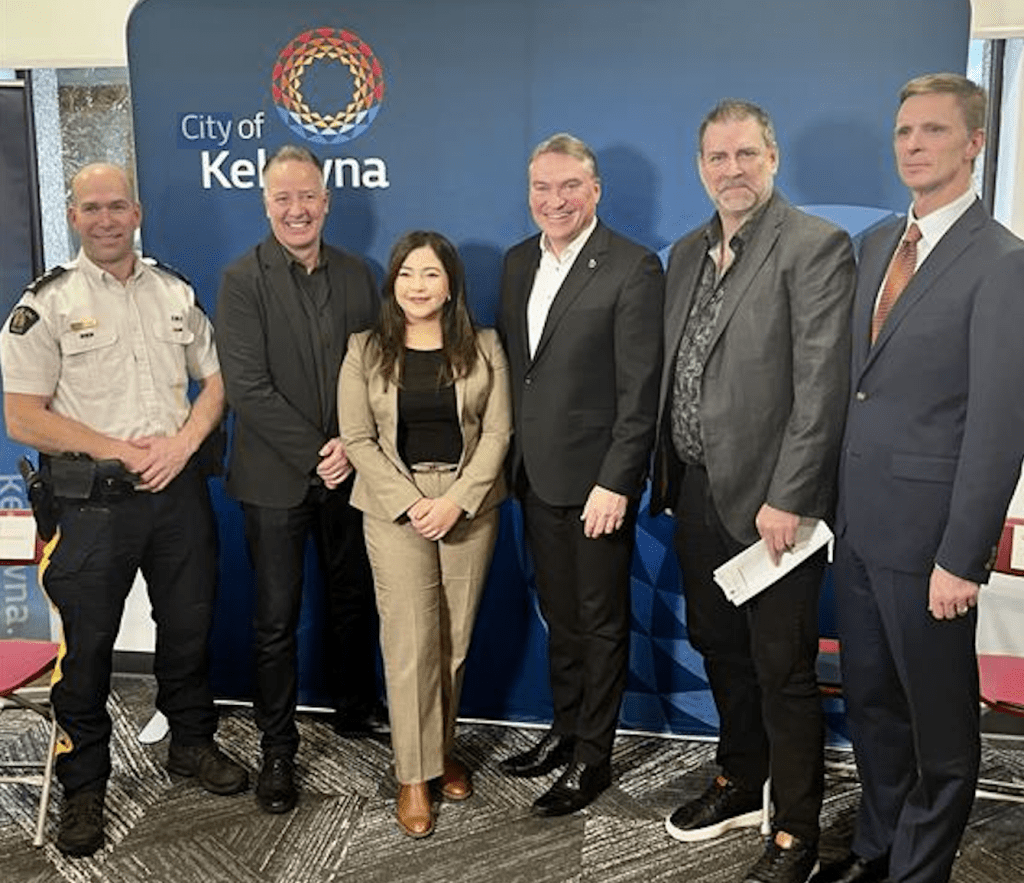 Non-police mental health crisis response team coming to Kelowna | iNFOnews.ca Six people standing in front of a City of Kelowna banner.