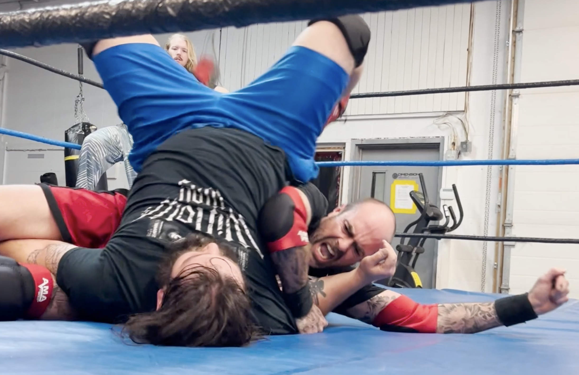 iN VIDEO: Behind the scenes as Okanagan pro wrestlers get ready for 'One Crazy Night' | iNFOnews.ca Two pro wresters rolling around in the ring.
