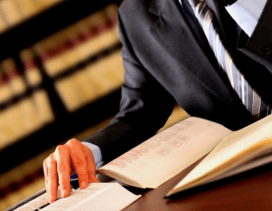 A lawyer looks at a book on his desk.