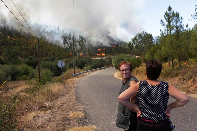 The Latest: Forest fire threatens homes on Greek island | iNFOnews.ca
