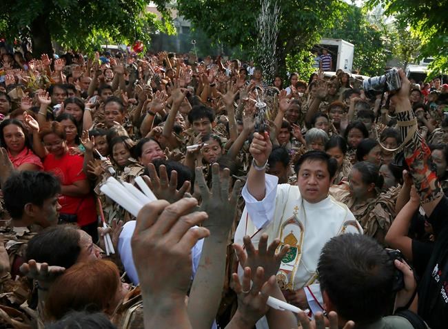 Mud-splattered Filipinos pray to saint for blessing and woes | iNFOnews.ca
