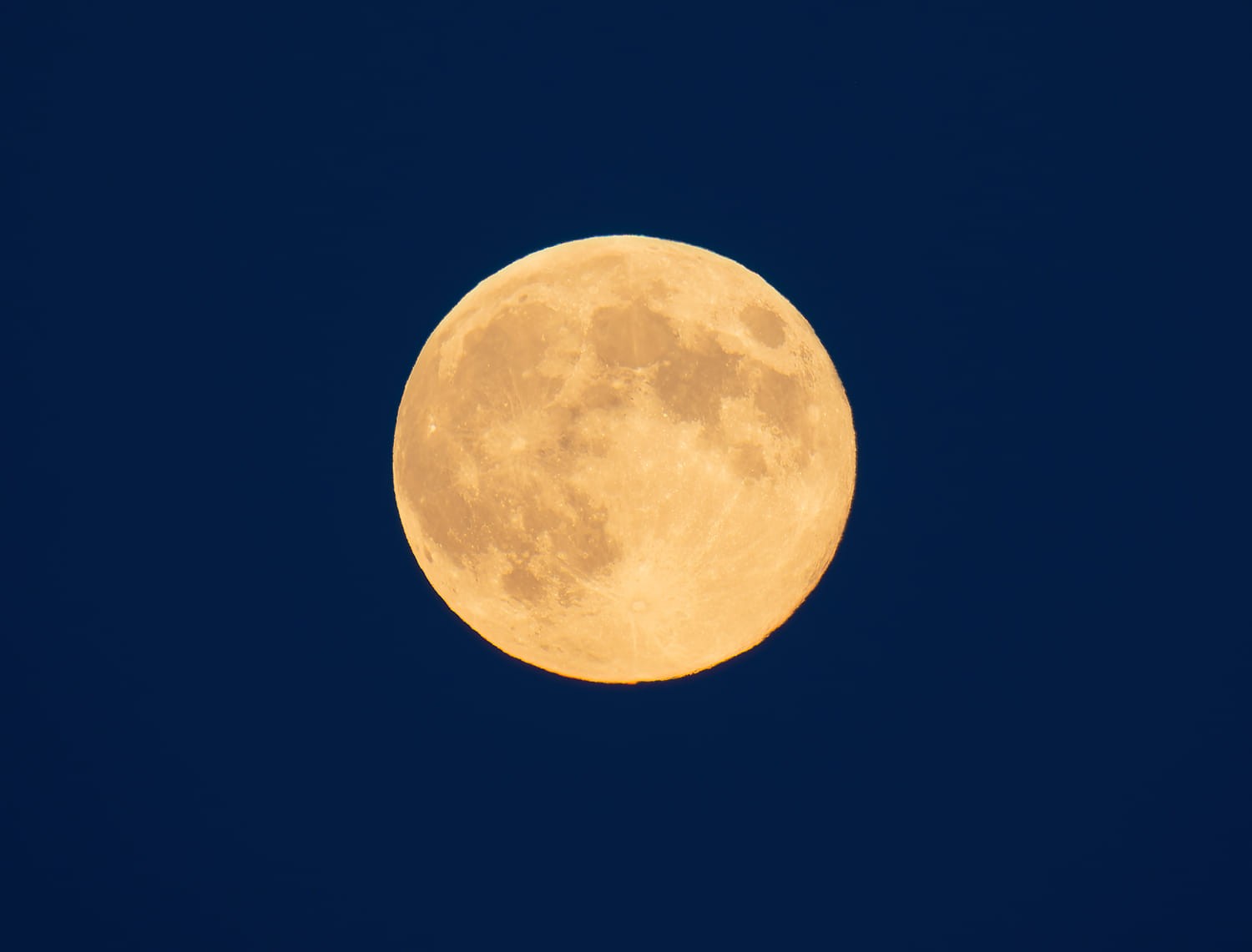 Second supermoon of year this week in Okanagan, Kamloops | iNFOnews.ca A perfectly round full moon with an orange tint is surrounded by a dark blue sky.