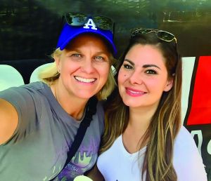 Two women smile in a selfie photo.