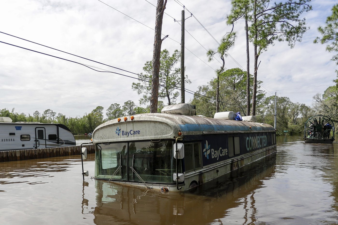 Residents slog through flooded streets, clear debris after Hurricane Milton tore through Florida | iNFOnews.ca