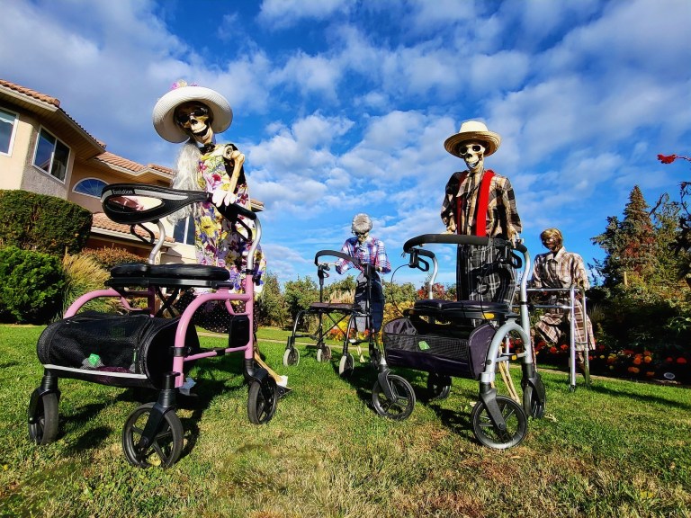 iN PHOTOS: Elaborate Halloween displays pop up in Kamloops, Okanagan | iNFOnews.ca Four life-sized skeletons dressed as seniors are staged on a lawn pushing walkers on wheels.