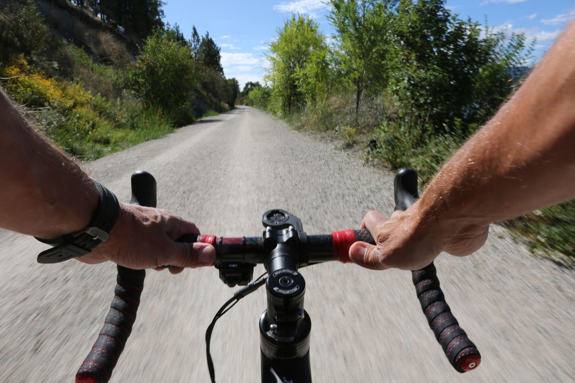 Missing piece of Okanagan Rail Trail in Kelowna to open this summer | iNFOnews.ca A POV photo of someone riding a bike.