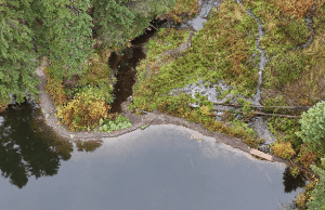 Aerial photo of a lake with a gravel dam