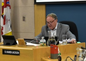 A photo of Reid Hamer-Jackson in city council chambers.