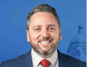 Headshot of a man in a suit.