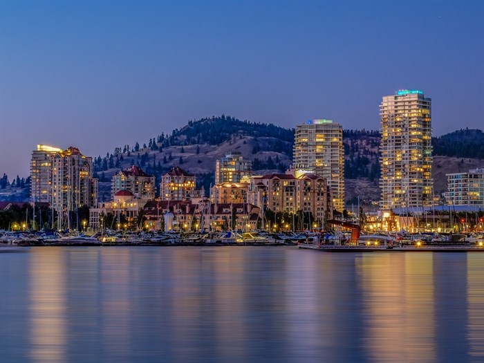 The land involved in Kelowna's $28M hotel development has a rocky history | iNFOnews.ca A city on a lake at night.
