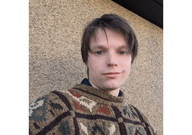 A selfie of a man in a hooded sweatshirt.