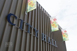 An exterior wall with signage reading, "City Hall."