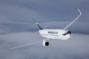 A WestJet airliner flying over clouds.