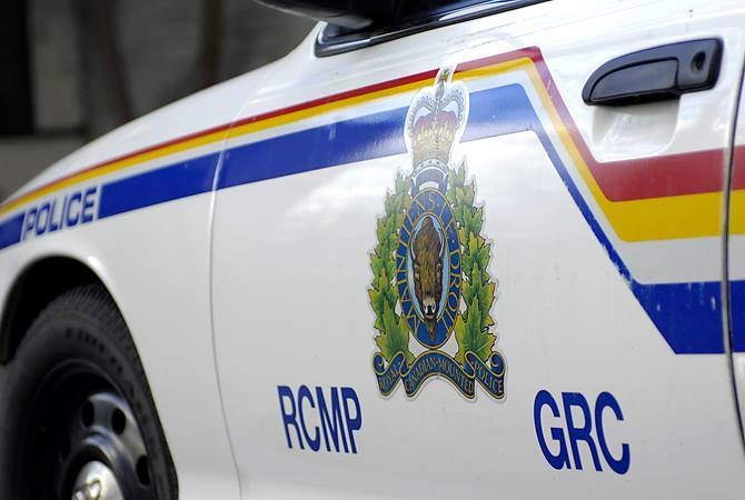 Kelowna man arrested after multiple vehicle fires  | iNFOnews.ca A close-up of the side of an RCMP vehicle.