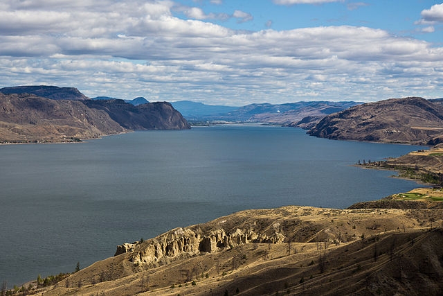 Body recovered after swimmer drowns in Kamloops lake | iNFOnews.ca Aerial image showing a lake surrounded by arid mountains.